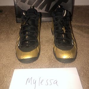 Metallic gold and black Nike foams